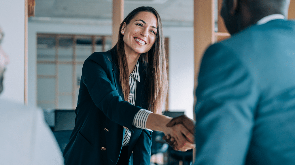 woman shaking hands with a client