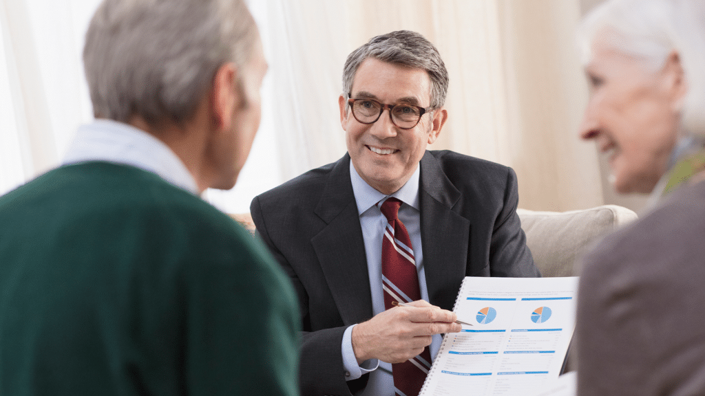Senior couple getting advice from their financial consultant at home